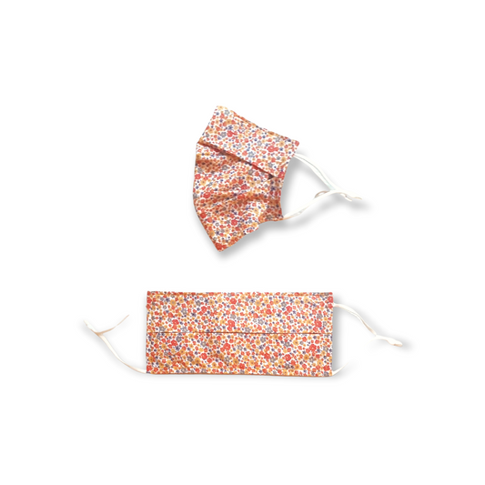 Orange ditsy face mask. Washable and reusable with filter pocket. Adjustable elastic ear loops with toggle adjustment.